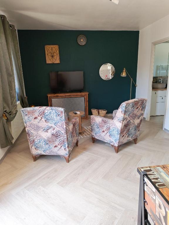 a living room with two chairs and a television at Mareva House - Discreet with parking in Gignac-la-Nerthe