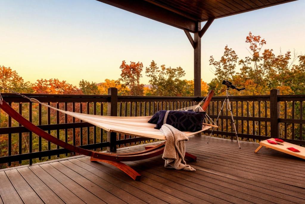 a person laying in a hammock on a deck at Open Skydeck with Spectacular View and Hot Tub in Sevierville