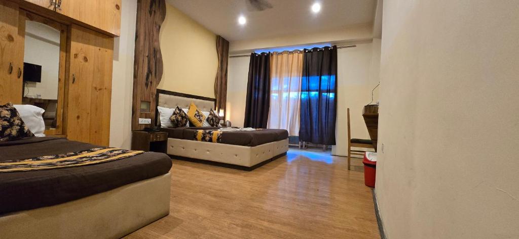 a bedroom with two beds and a window at The White Yak Hotel in Leh
