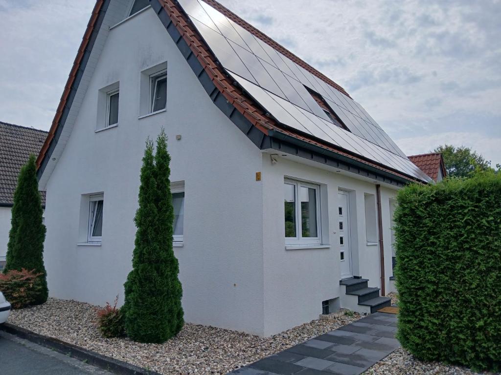 a white house with a gambrel roof at Ferien-Appartement Schröer in Nordwalde