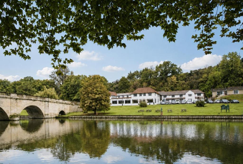 a bridge over a lake in front of a building at Shillingford Bridge Hotel in Wallingford