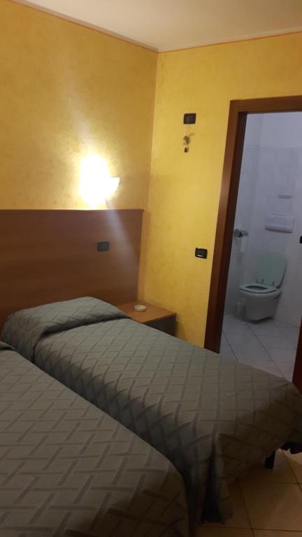 Postel nebo postele na pokoji v ubytování Hotel Armida