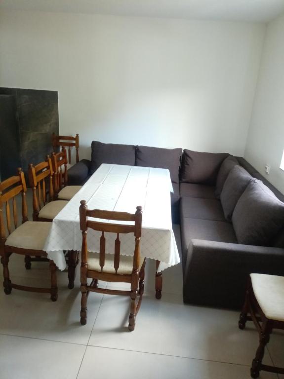 a living room with a table and a couch at Komarnica Willage home in Šavnik