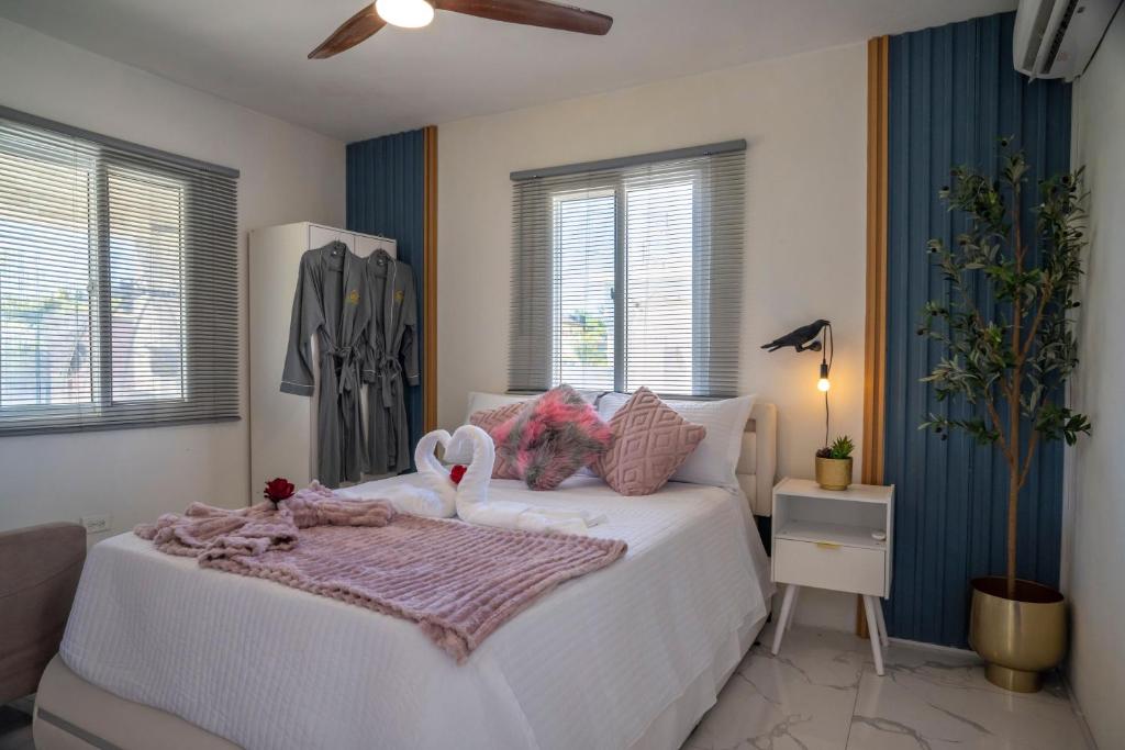 a bedroom with a white bed with stuffed animals on it at Bselifestyle in Green Island