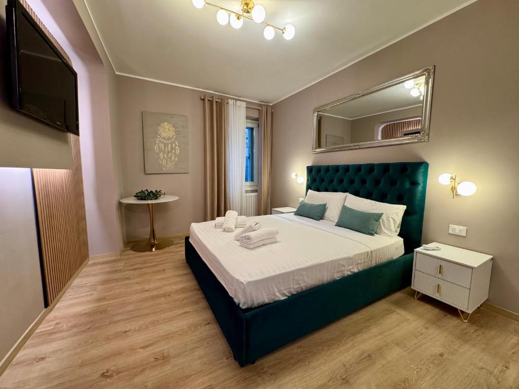 a bedroom with a large bed and a mirror at Duomo Next Accomodations in Trento