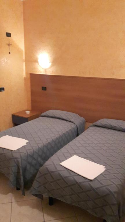 Postel nebo postele na pokoji v ubytování Hotel Armida