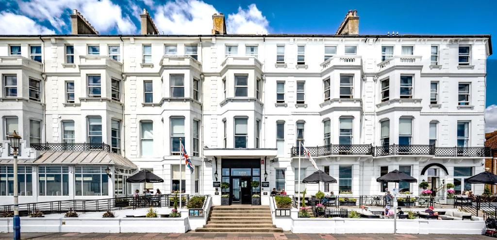 a large white building with stairs in front of it at Langham Hotel Eastbourne in Eastbourne