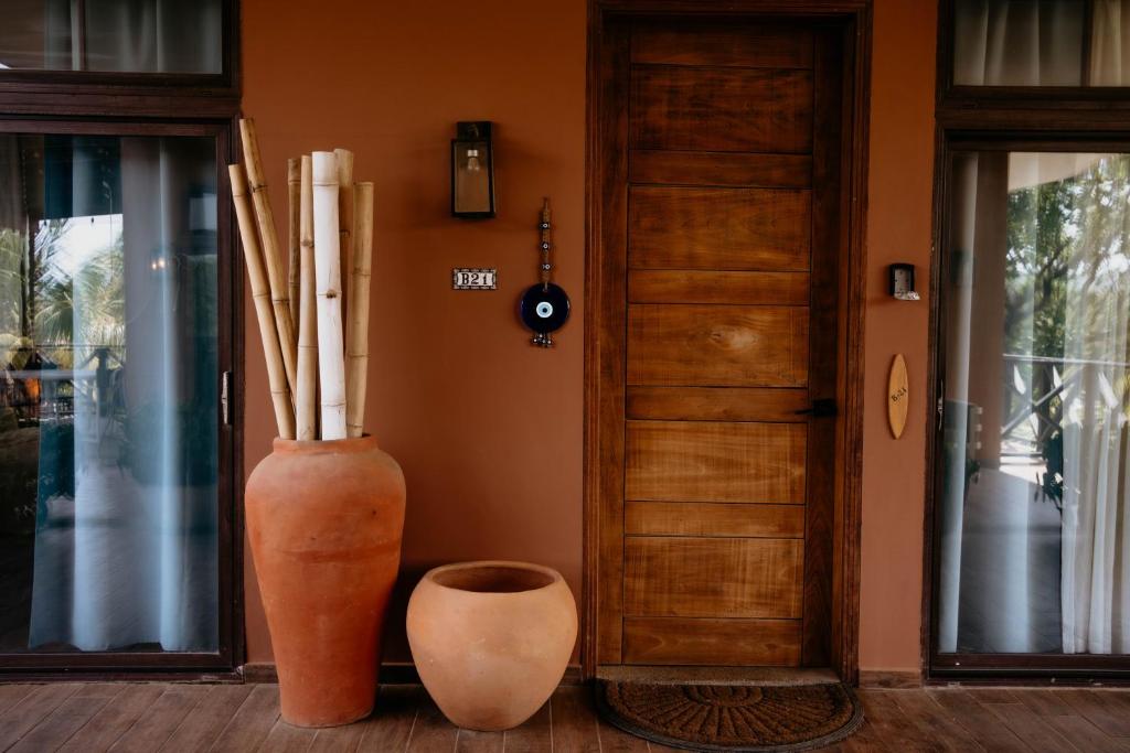 a room with two large vases next to a door at Ocean & Lighthouse view apartment in Playa Venao