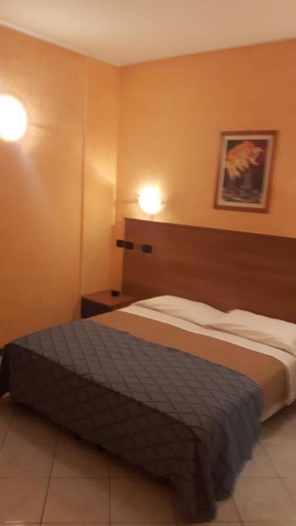Postel nebo postele na pokoji v ubytování Hotel Armida
