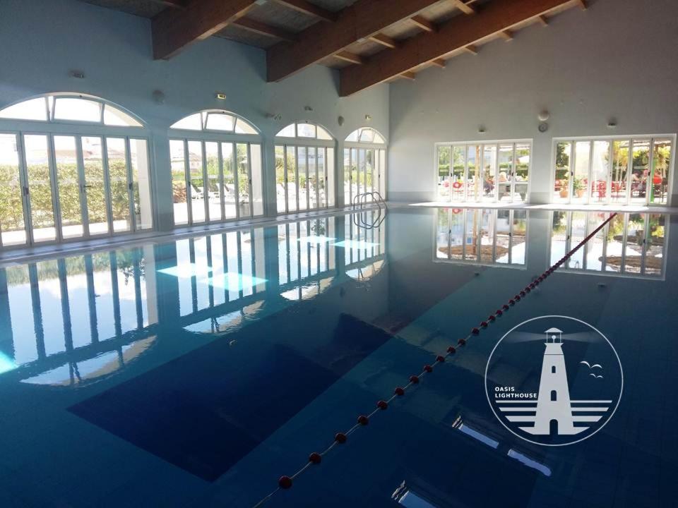 a large swimming pool with a lighthouse on it at Oasis Lighthouse in Portimão