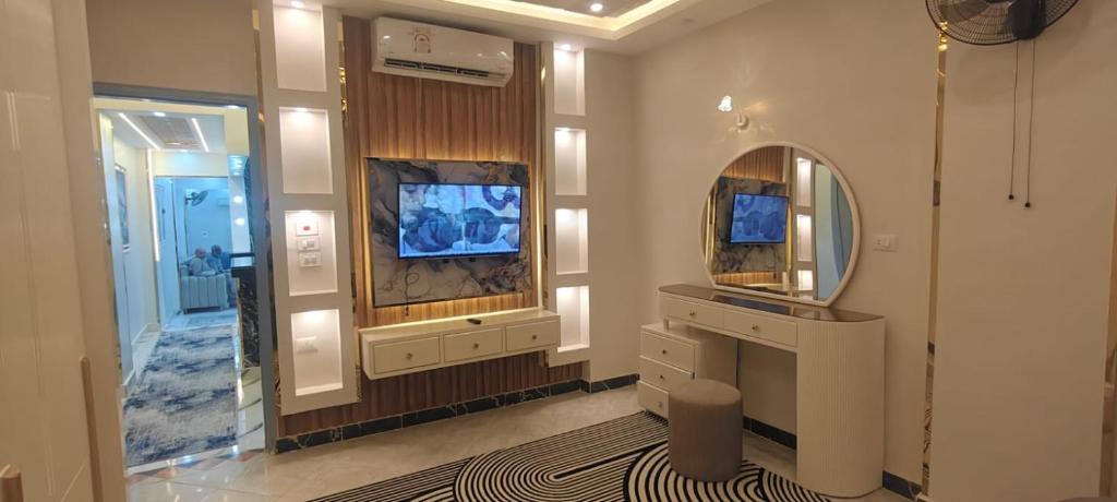 a bathroom with a mirror and a dressing room at Couple's Cove in Luxor