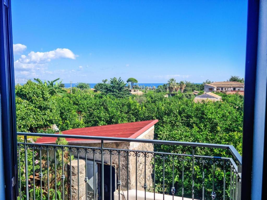 a balcony with a view of the ocean at La Casa del Cedro - Riposto in Riposto