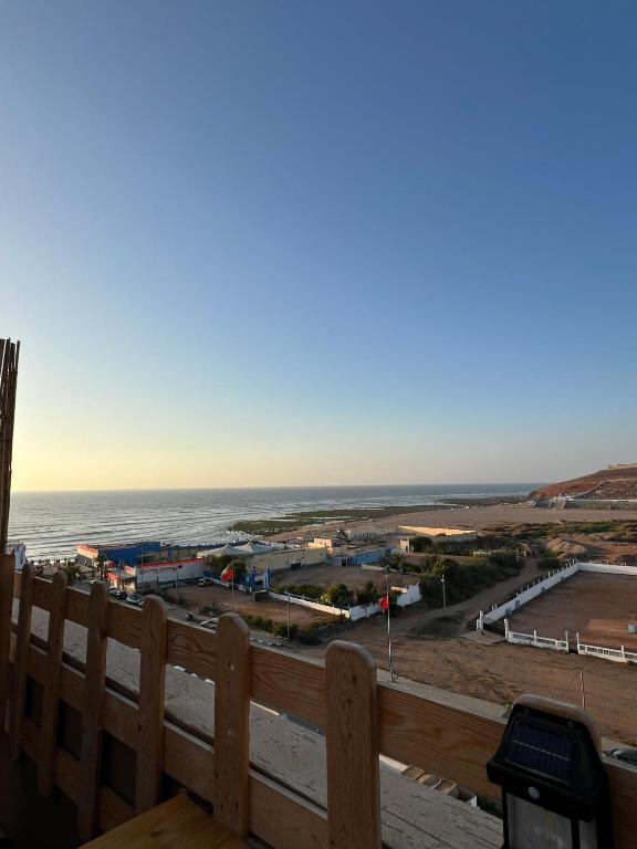 a view of the beach from the balcony of a house at Ifni Flow Seafront surfhouse in Sidi Ifni