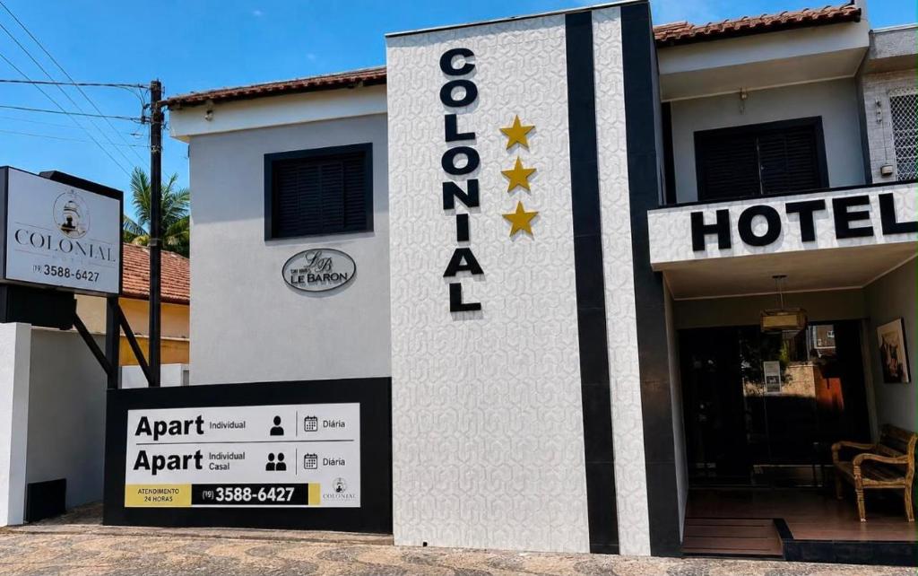 a hotel sign in front of a building at Hotel Colonial in Pôrto Ferreira