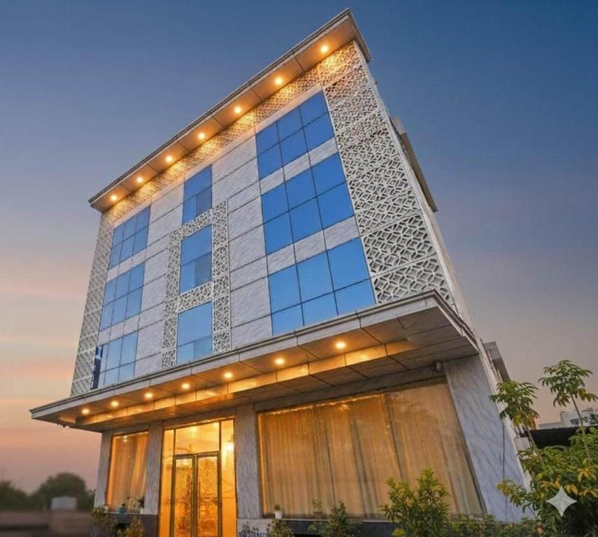 a building with lights on top of it at Hotel Grand Suites Premier - Near Delhi Aerocity in New Delhi