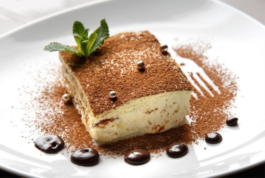 a piece of cake on a white plate with a fork at Turismo Associativo Giovanile asd in Borgofranco dʼIvrea