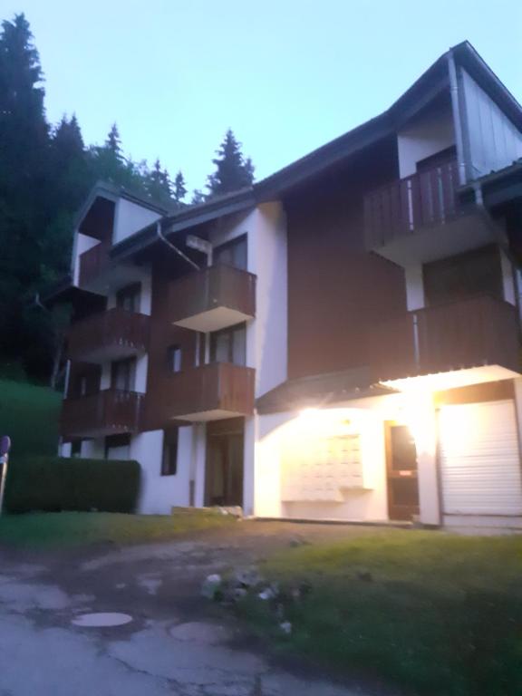 a large apartment building with the lights on at Studio montagne in Mijoux