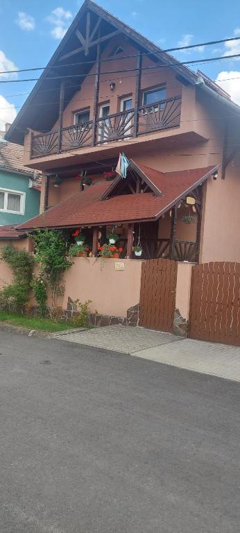 a building with a restaurant on the side of it at Lörincz Vendégház in Corund