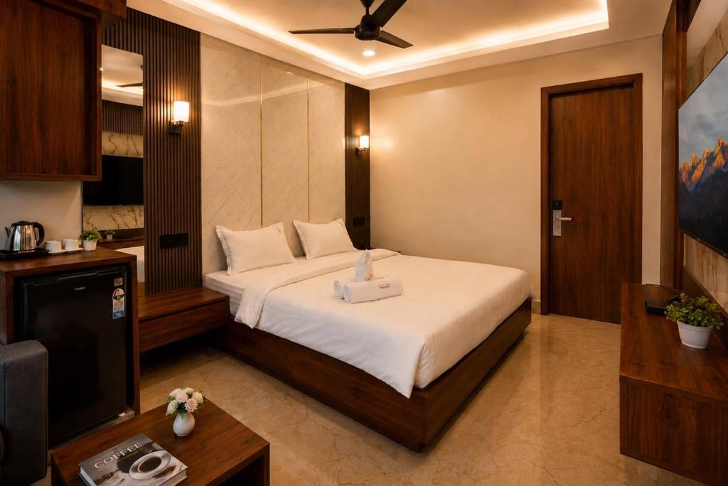a hotel room with a bed and a television at Hotel Uasa Kesari Premium in Jājpur