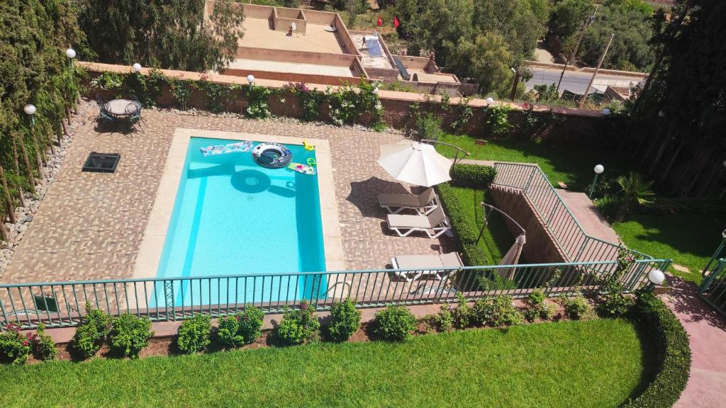 an overhead view of a swimming pool with an umbrella at Marrakech Le Joyau de l'ourika in Ourika