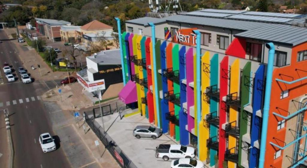 a building with a colorful facade on a city street at Apartment Next to Hotel in Pretoria