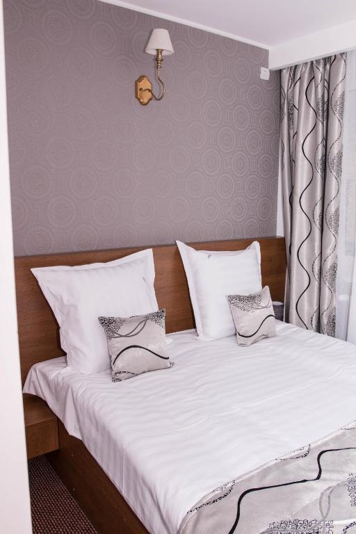 Postel nebo postele na pokoji v ubytování Hotel Magurele