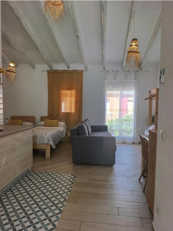 a living room with a couch and a bed at Loft C El Ramellet in Alginet