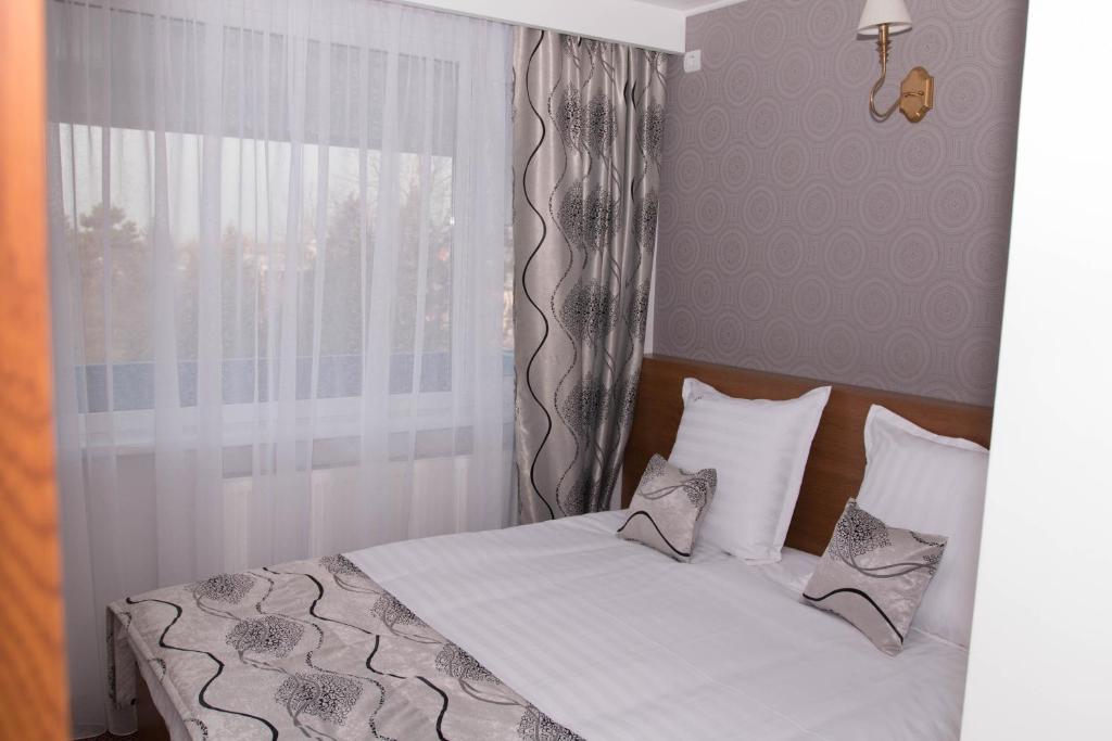 Postel nebo postele na pokoji v ubytování Hotel Magurele