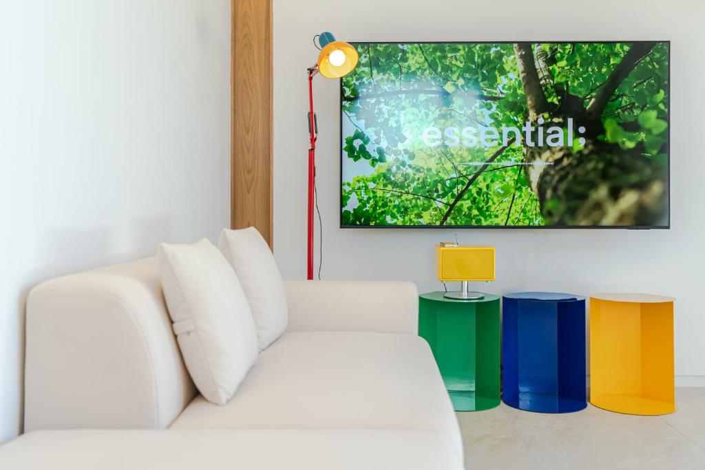 a living room with a white couch and a tv at 제주살랑 in Tŏksu-dong