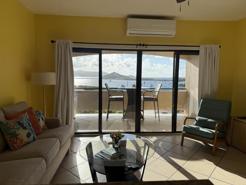 a living room with a couch and a table at Charming 1BR Villa Steps from Red Hook Hotspots in Nazareth