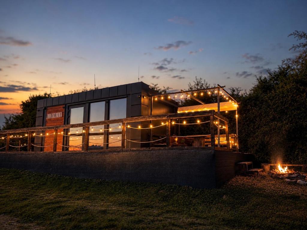 a building with lights on it at night at Sidehill - zážitkové ubytovanie v prírode in Martin