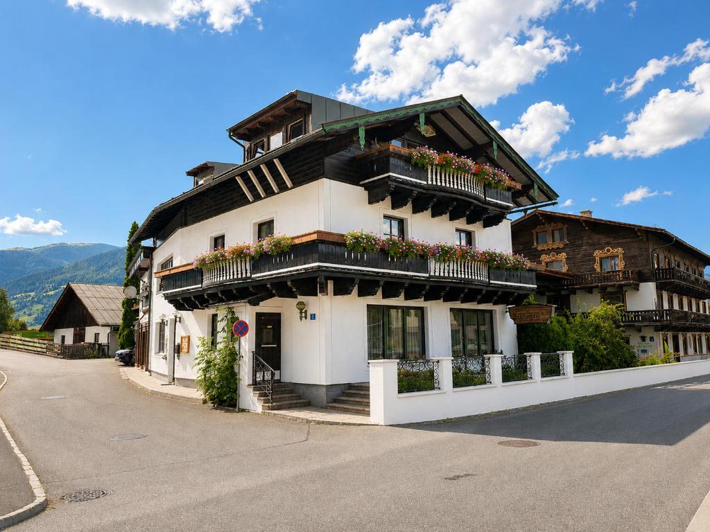a building with flowers on the balconies on a street at Appartement Schönpflug in Kaprun