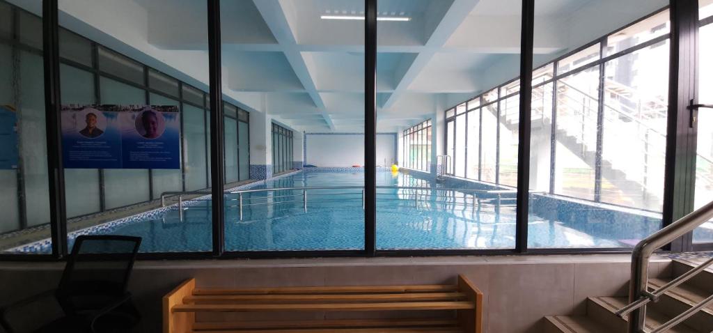 a swimming pool in a building with windows at Meteor Garden in Nairobi
