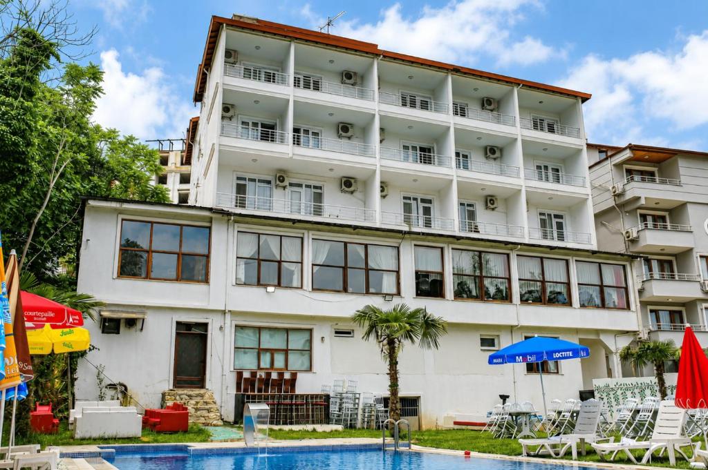 a hotel with a pool in front of it at Green Moringa Termal Hotel in Termal