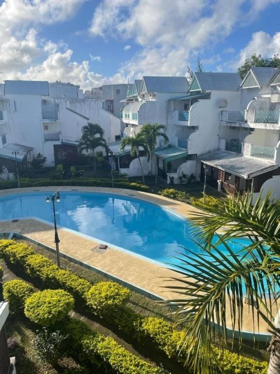 a large swimming pool in front of a building at Blue Haven in Grand-Baie