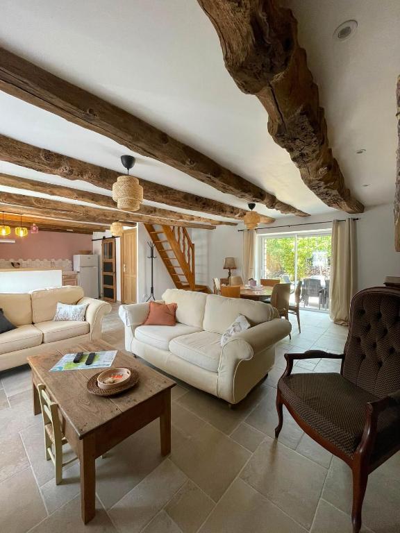 a living room with two couches and a table at La Maison de Gautro in Tréhorenteuc