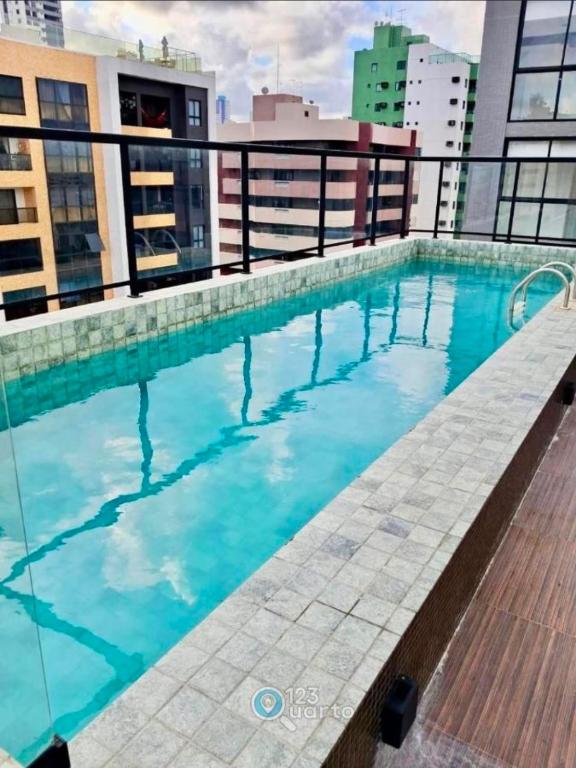a swimming pool on the roof of a building at Solon Flat Manaira in João Pessoa