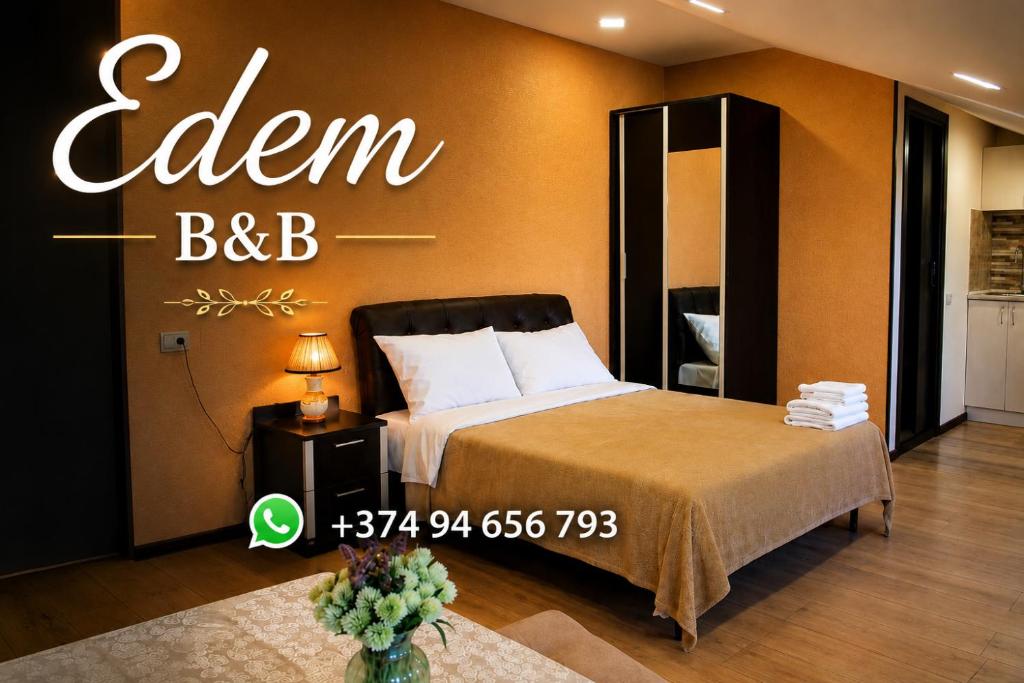 a bedroom with a bed with a sign on the wall at Edem B&B in Sevan