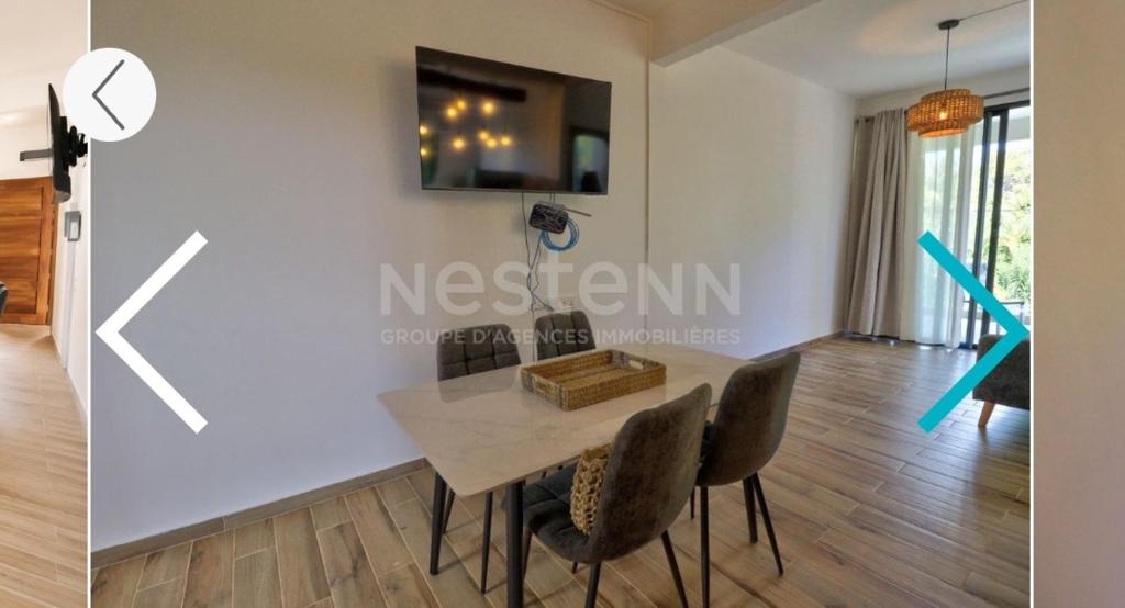 a dining room with a table and chairs at Maranatha Villa in La Gaulette