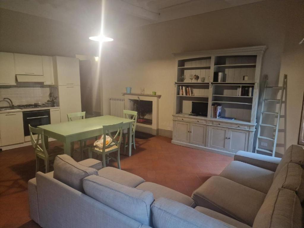 a living room with a couch and a table at Attico le due Torri in Arezzo
