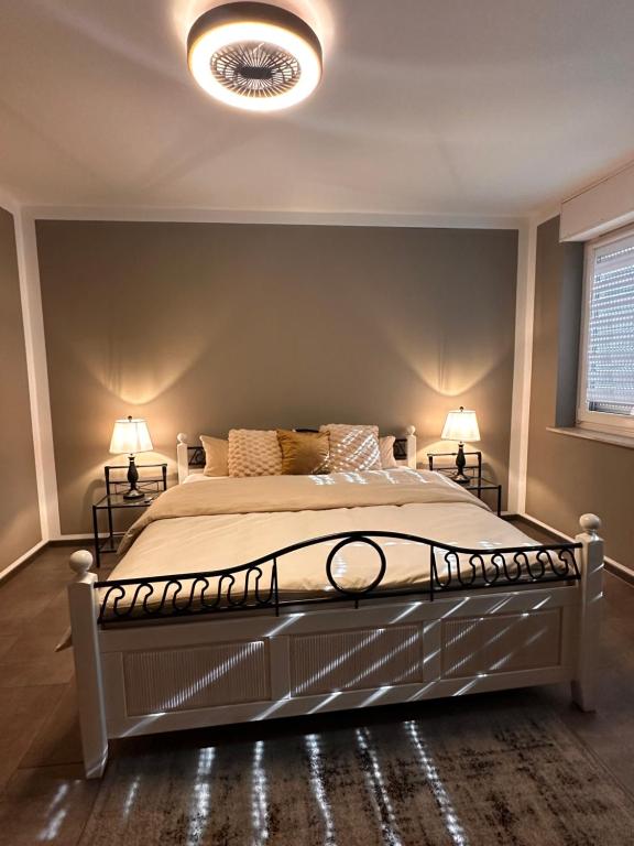 a bedroom with a large bed with two lamps at Ferienwohnung EG in Gräfenhainichen