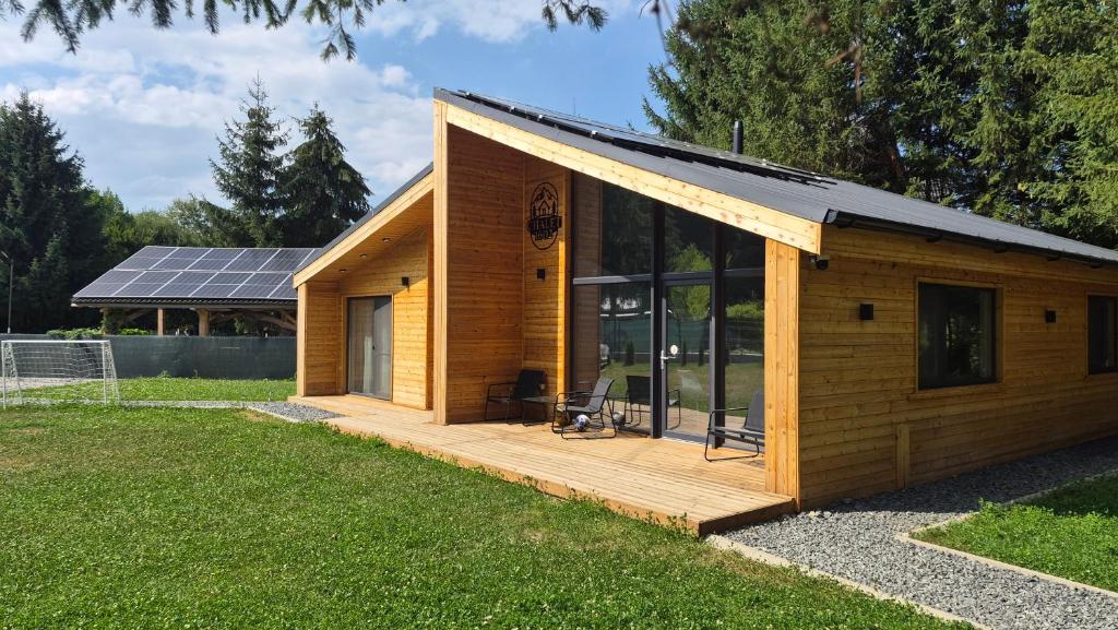 a small wooden building with a solar roof at Chalet 1602 in Avrig