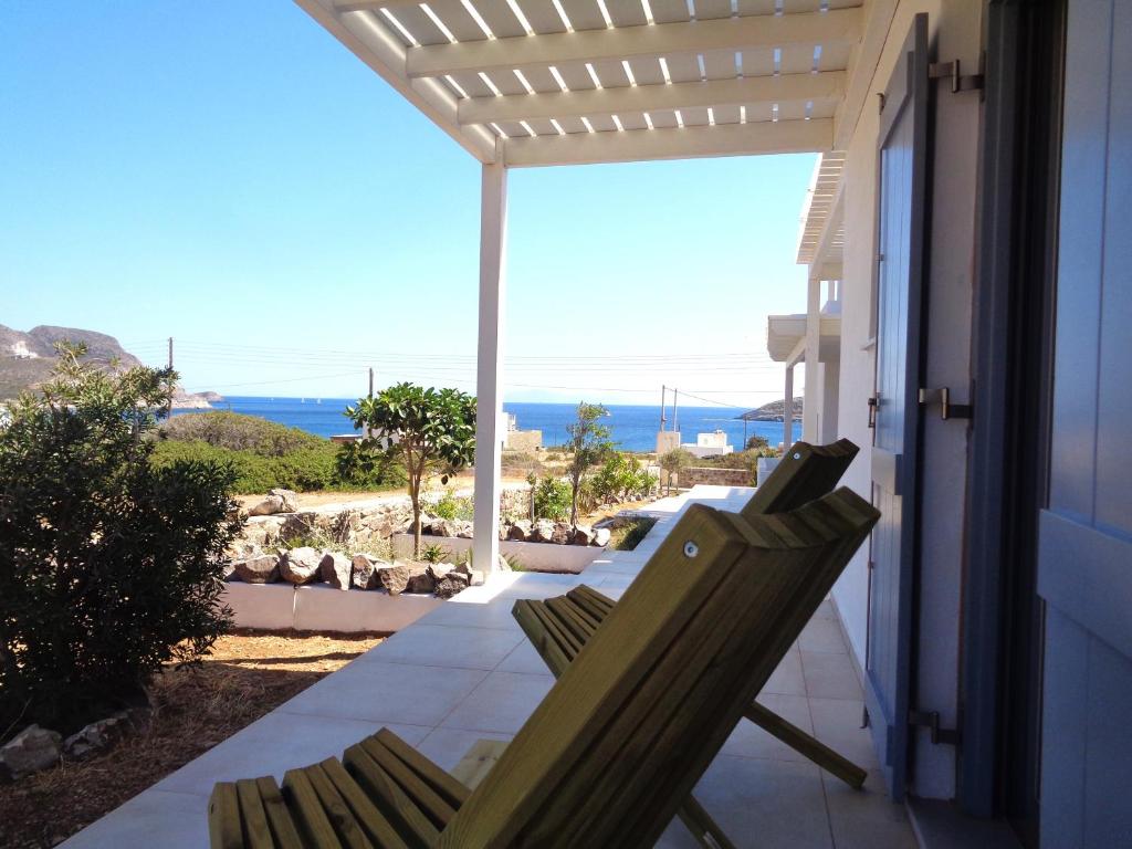 a pair of chairs sitting on the porch of a house at Villa Ploes in Agios Georgios