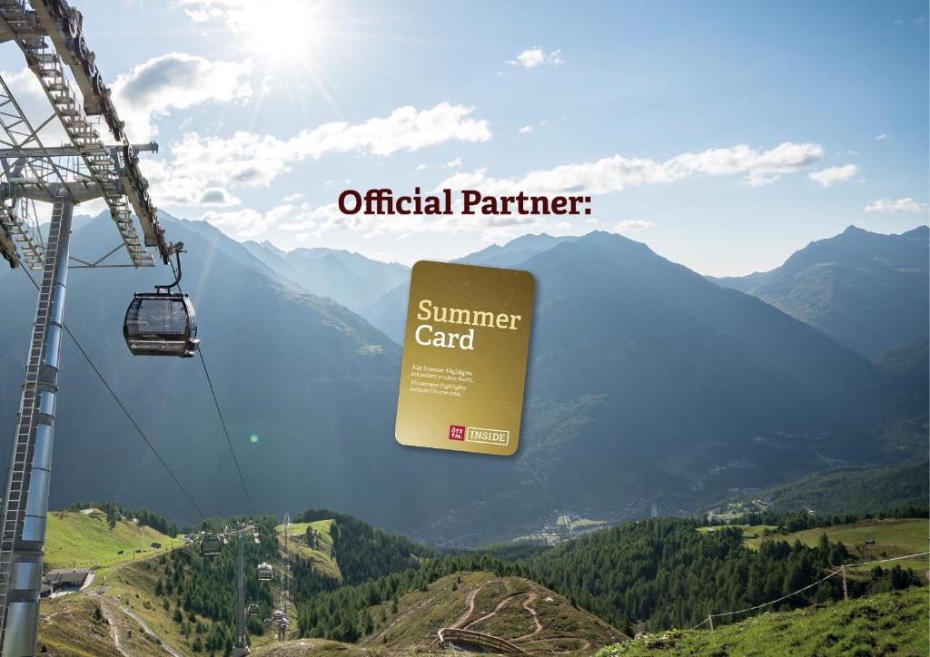 a sign for a summer card hanging from a ski lift at Tonis Ferienheim in Sölden