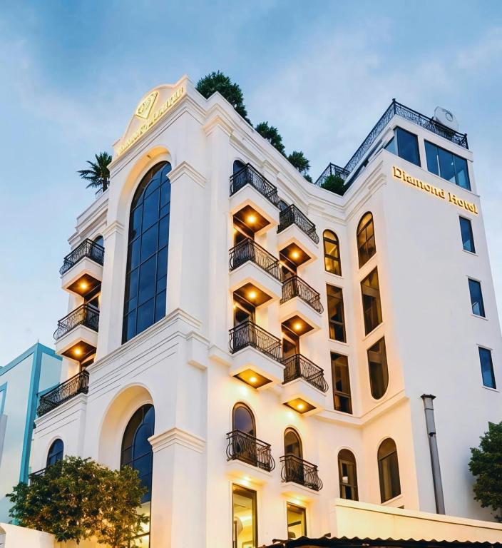 a white building with balconies on it at Diamond Hotel in Bien Hoa