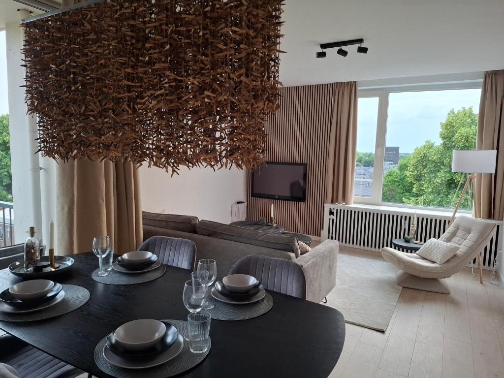 a living room with a table and a couch at Apartment with skyline view in Eindhoven