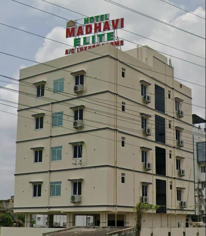 a building with a sign on top of it at HoTEL MADHAVI ELITE in Vijayawāda