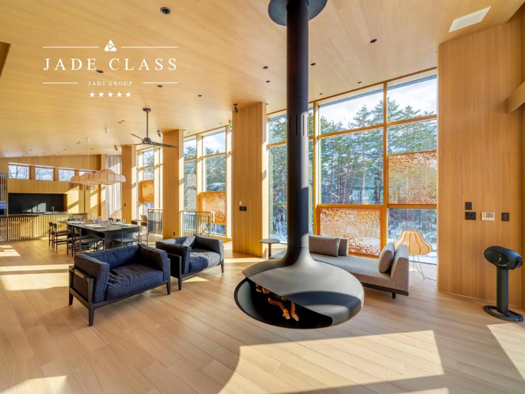a living room with a fireplace in a house at JADE Amber Resort Hakuba in Hakuba