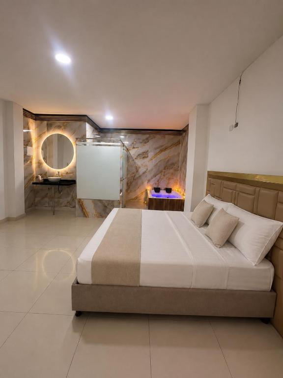 a bedroom with a large bed in a room at HOTEL LUXURY v in Valledupar