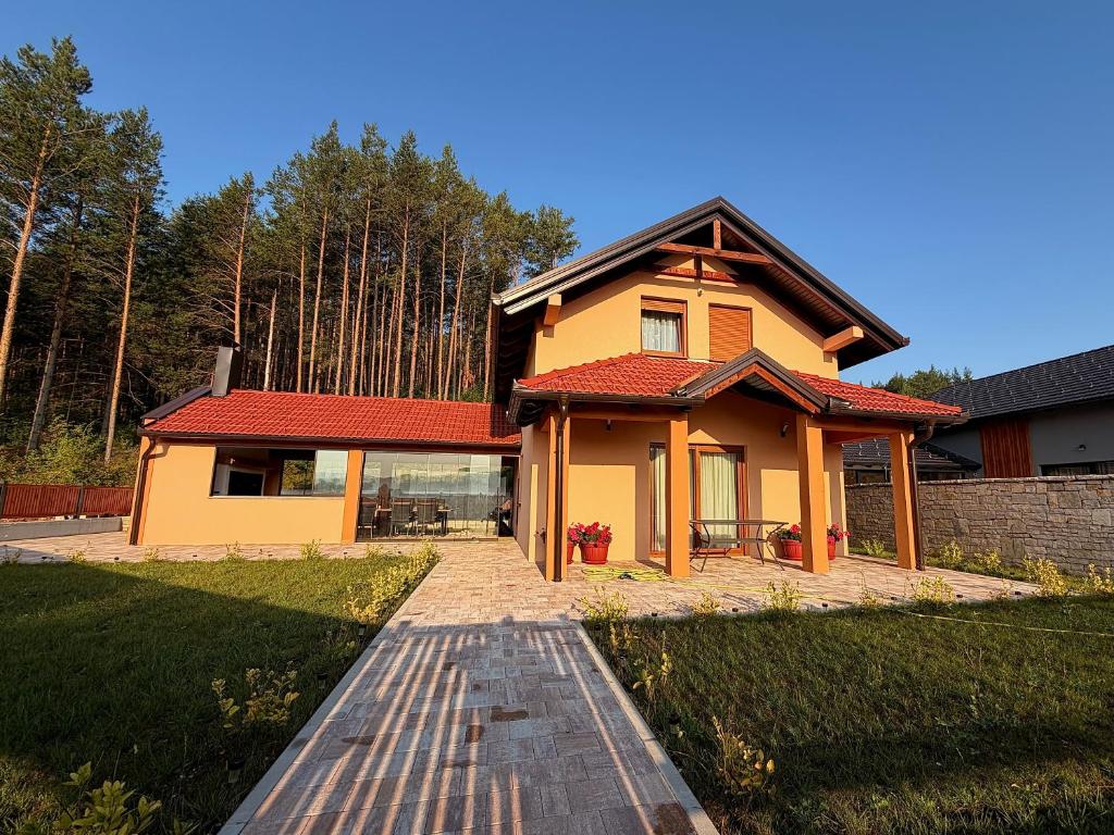 a small yellow house with a red roof at Kuća za odmor Bruna in Livno